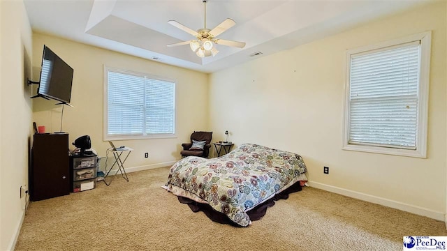 2423 Ben Hogan Cir, Florence, SC 29506 - bedroom with carpet flooring, baseboards, a raised ceiling, and ceiling fan