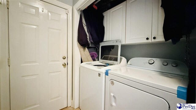2423 Ben Hogan Cir, Florence, SC 29506 - laundry area featuring washer and clothes dryer and cabinet space
