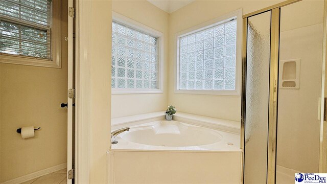 2423 Ben Hogan Cir, Florence, SC 29506 - bathroom featuring plenty of natural light, a stall shower, a bath, and tile patterned flooring