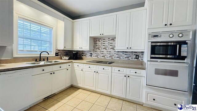 2423 Ben Hogan Cir, Florence, SC 29506 - kitchen with white appliances, a sink, light tile patterned flooring, tasteful backsplash, and white cabinetry