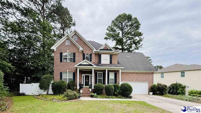 2423 Ben Hogan Cir, Florence, SC 29506 - view of front of property with brick siding, concrete driveway, and a garage