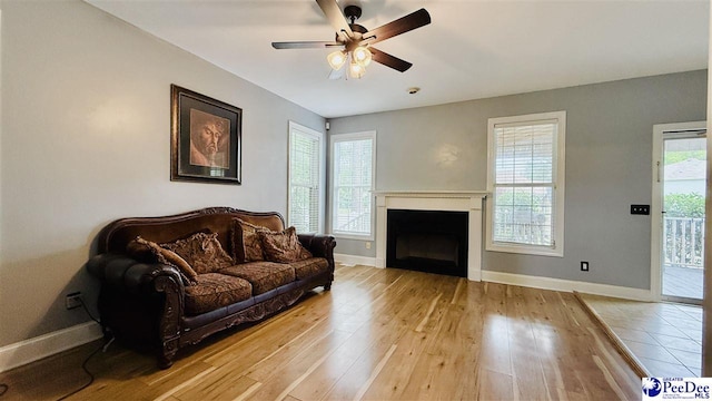 2423 Ben Hogan Cir, Florence, SC 29506 - living area with baseboards, ceiling fan, light wood-style floors, and a fireplace