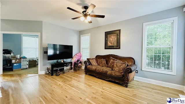 2423 Ben Hogan Cir, Florence, SC 29506 - living area with wood finished floors, a ceiling fan, and baseboards