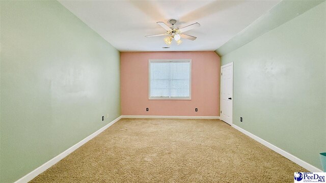 2423 Ben Hogan Cir, Florence, SC 29506 - spare room with a ceiling fan, baseboards, and light colored carpet