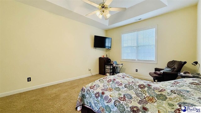2423 Ben Hogan Cir, Florence, SC 29506 - bedroom featuring light carpet, baseboards, a raised ceiling, and ceiling fan