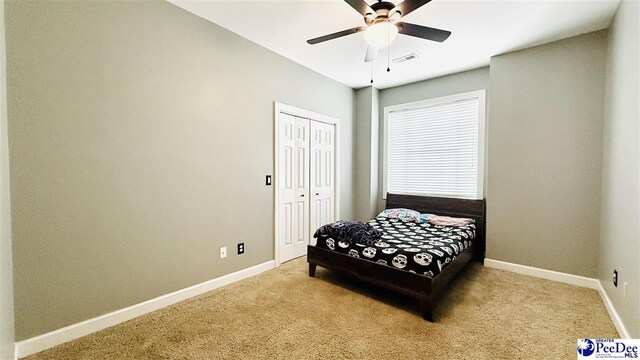2423 Ben Hogan Cir, Florence, SC 29506 - bedroom featuring carpet flooring, baseboards, a closet, and a ceiling fan