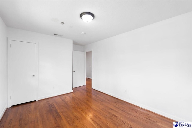 2206 W Piccadilly Dr, Florence, SC 29501 - unfurnished bedroom featuring baseboards and wood finished floors