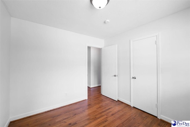 2206 W Piccadilly Dr, Florence, SC 29501 - unfurnished bedroom featuring wood finished floors and baseboards