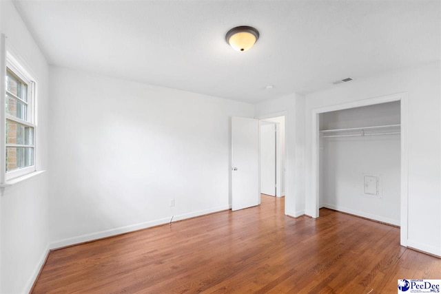 2206 W Piccadilly Dr, Florence, SC 29501 - unfurnished bedroom with wood finished floors, baseboards, and a closet