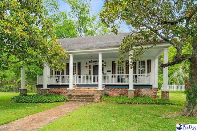 view of front of property with a front yard and a porch