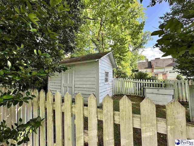 view of side of property with a shed