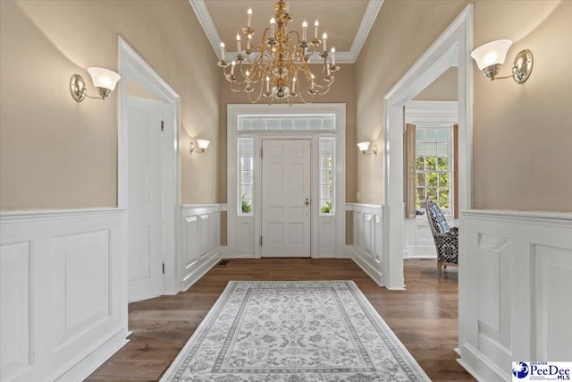 foyer with crown molding and dark wood-type flooring