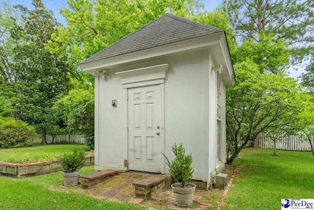 view of outdoor structure with a lawn