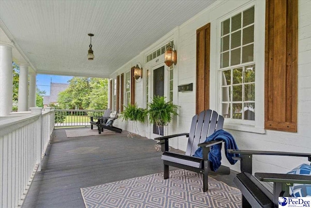 wooden terrace featuring covered porch