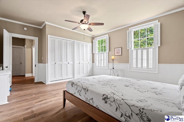 bedroom with ceiling fan, ornamental molding, and light hardwood / wood-style floors