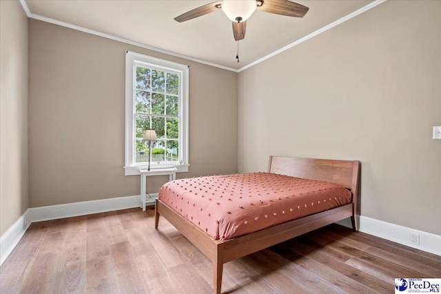 bedroom with crown molding, ceiling fan, and hardwood / wood-style floors