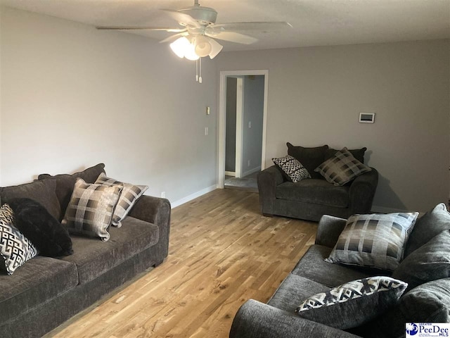 living room featuring hardwood / wood-style flooring and ceiling fan