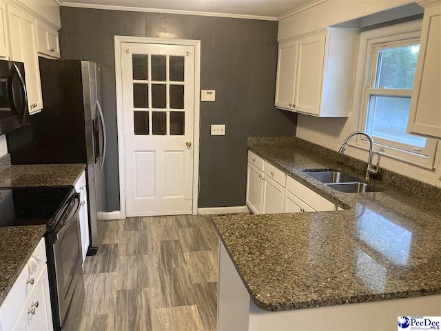 kitchen featuring sink, stainless steel electric range, and white cabinets