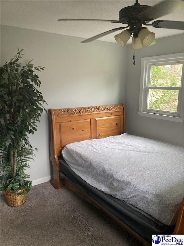 bedroom featuring ceiling fan and carpet