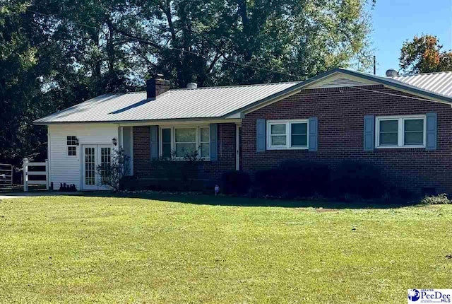 single story home featuring a front lawn and french doors