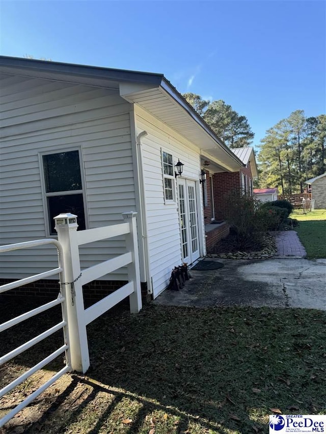 view of side of property with a patio area and french doors