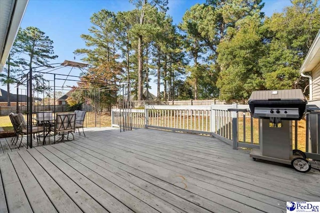 wooden terrace with a grill