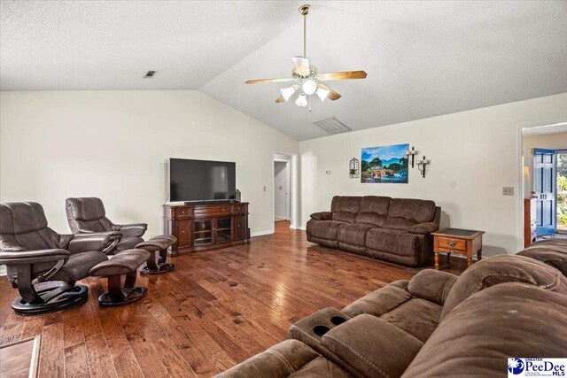 living room featuring vaulted ceiling, hardwood / wood-style floors, a textured ceiling, and ceiling fan