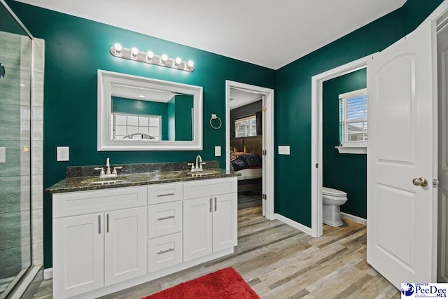 bathroom with a shower with door, a wealth of natural light, hardwood / wood-style floors, and toilet