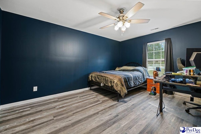 bedroom with hardwood / wood-style floors and ceiling fan