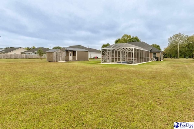 view of yard with a storage shed and a lanai