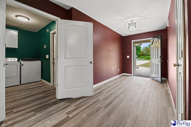 entryway with washing machine and clothes dryer and light wood-type flooring