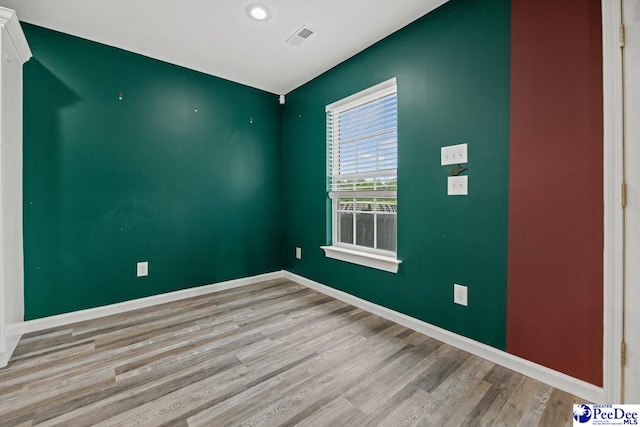 spare room featuring light wood-type flooring