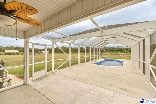 exterior space featuring a lanai, a patio, and a lawn