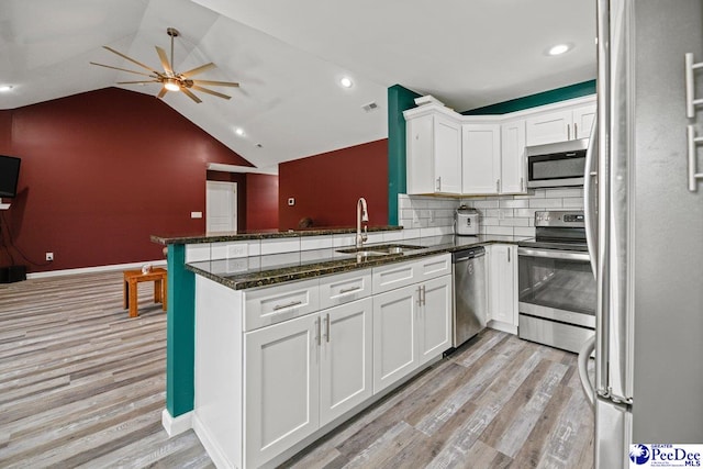 kitchen featuring sink, white cabinets, kitchen peninsula, stainless steel appliances, and light wood-type flooring