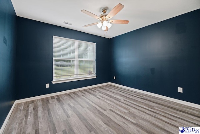 unfurnished room featuring light hardwood / wood-style floors and ceiling fan