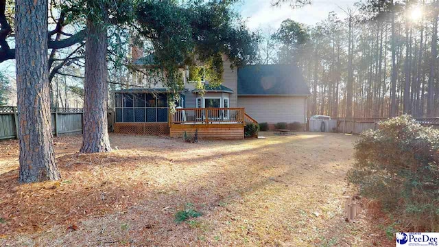 view of front of home featuring a wooden deck and a sunroom