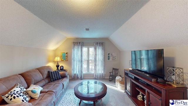 living room featuring vaulted ceiling, light colored carpet, and a textured ceiling