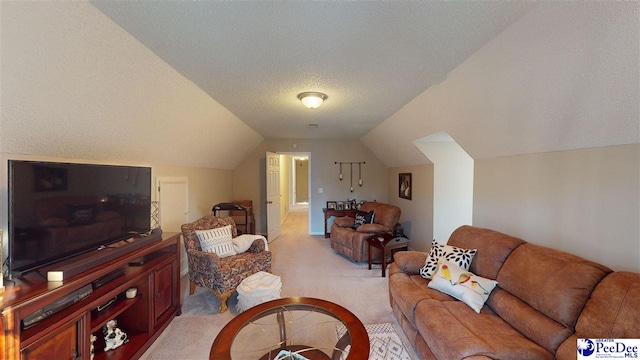 living room featuring vaulted ceiling, light colored carpet, and a textured ceiling