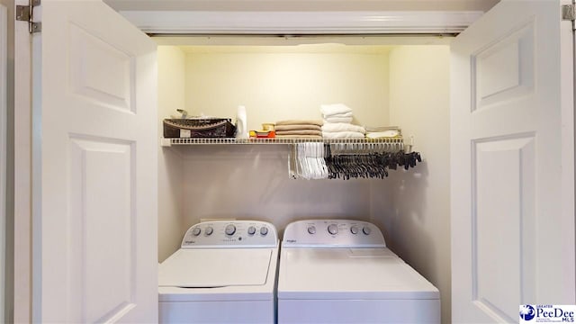 washroom with washing machine and clothes dryer