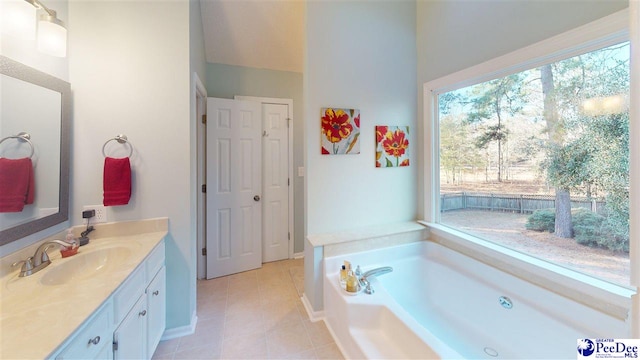 bathroom with tile patterned flooring, vanity, and a washtub