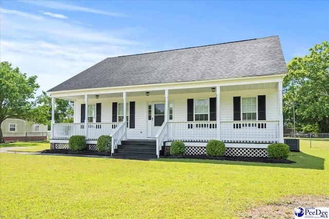 1763 Lipscomb Rd, Mullins, SC 29574 - view of front of house featuring a porch, roof with shingles, a front lawn, and central air condition unit