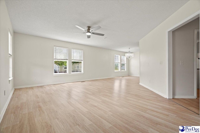 1763 Lipscomb Rd, Mullins, SC 29574 - unfurnished room with a chandelier, ceiling fan, a textured ceiling, light wood finished floors, and baseboards