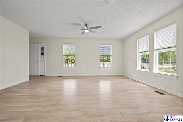 1763 Lipscomb Rd, Mullins, SC 29574 - unfurnished room featuring a ceiling fan, light wood-style floors, a textured ceiling, and baseboards