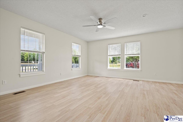 1763 Lipscomb Rd, Mullins, SC 29574 - empty room featuring light wood-type flooring, ceiling fan, a textured ceiling, and baseboards