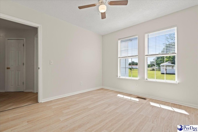 1763 Lipscomb Rd, Mullins, SC 29574 - empty room featuring a ceiling fan, light wood finished floors, a textured ceiling, and baseboards