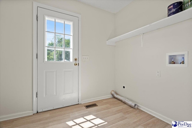 1763 Lipscomb Rd, Mullins, SC 29574 - laundry room with hookup for an electric dryer, washer hookup, light wood-type flooring, and baseboards