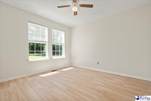 1763 Lipscomb Rd, Mullins, SC 29574 - spare room with wood finished floors, a ceiling fan, a textured ceiling, and baseboards