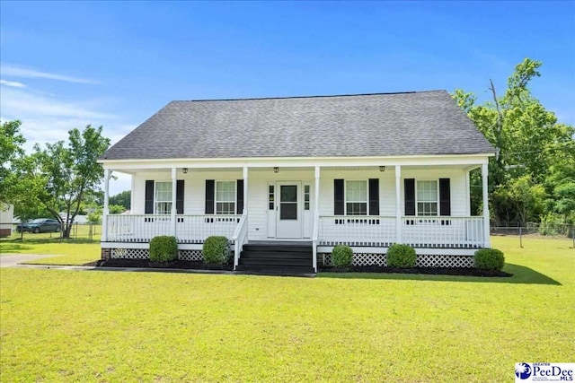 1763 Lipscomb Rd, Mullins, SC 29574 - view of front facade featuring covered porch, a shingled roof, and a front yard
