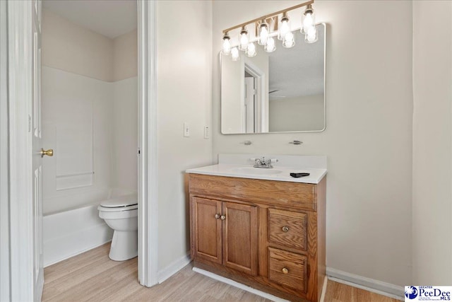 1763 Lipscomb Rd, Mullins, SC 29574 - bathroom with wood finished floors, toilet, vanity, and baseboards