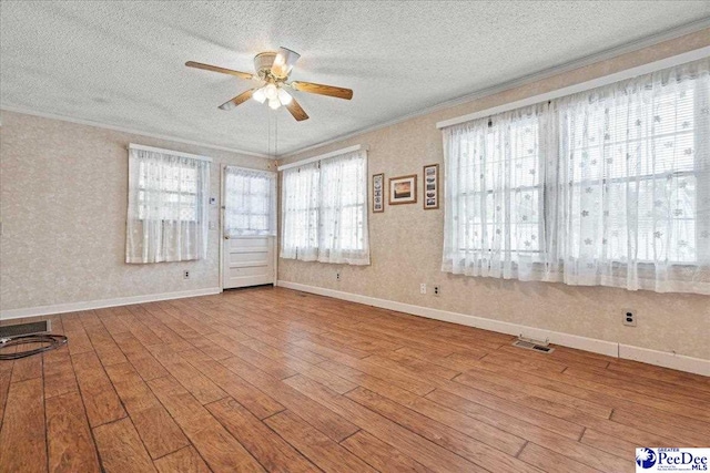 2810 Boxwood Ave, Florence, SC 29501 - spare room featuring crown molding, a ceiling fan, a textured ceiling, wood finished floors, and baseboards